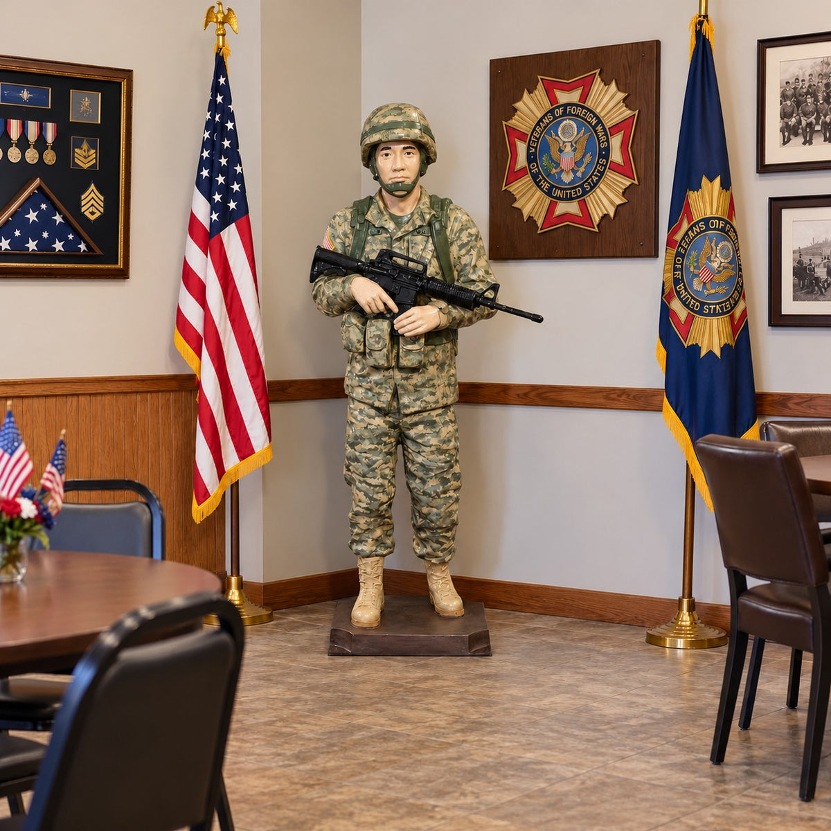 Cast aluminum 6-foot soldier holding a gun standing on a base.
