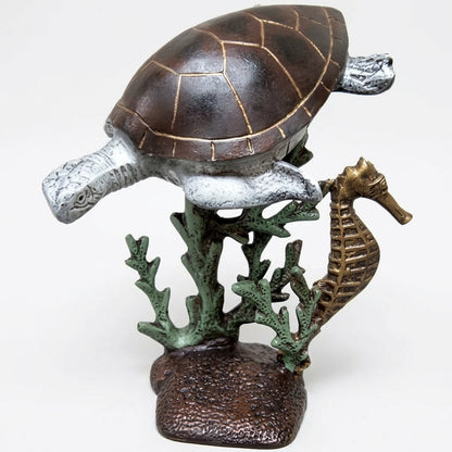 Cast aluminum sea turtle with a sea horse on a coral reef for interior home decor