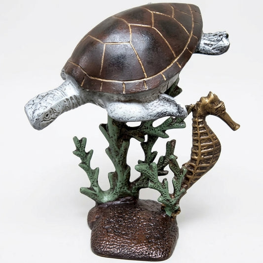 Cast aluminum sea turtle with a sea horse on a coral reef for interior home decor