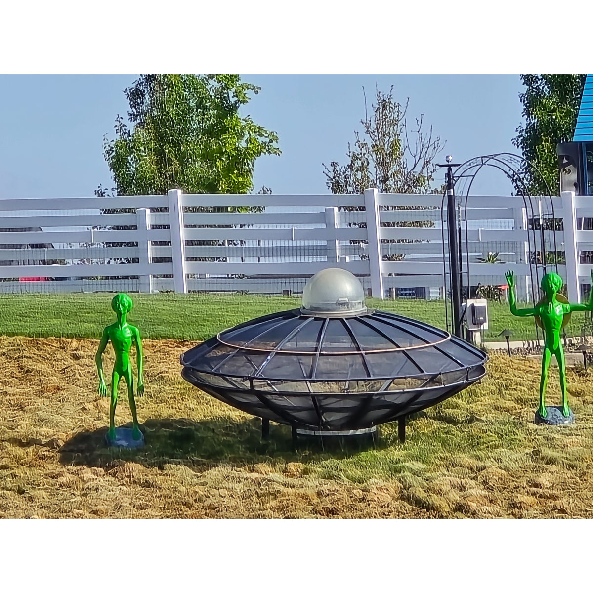 Cast aluminum aliens next to man made ufo
