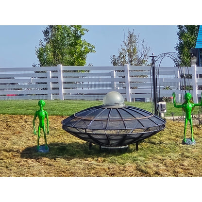 Cast aluminum aliens next to man made ufo