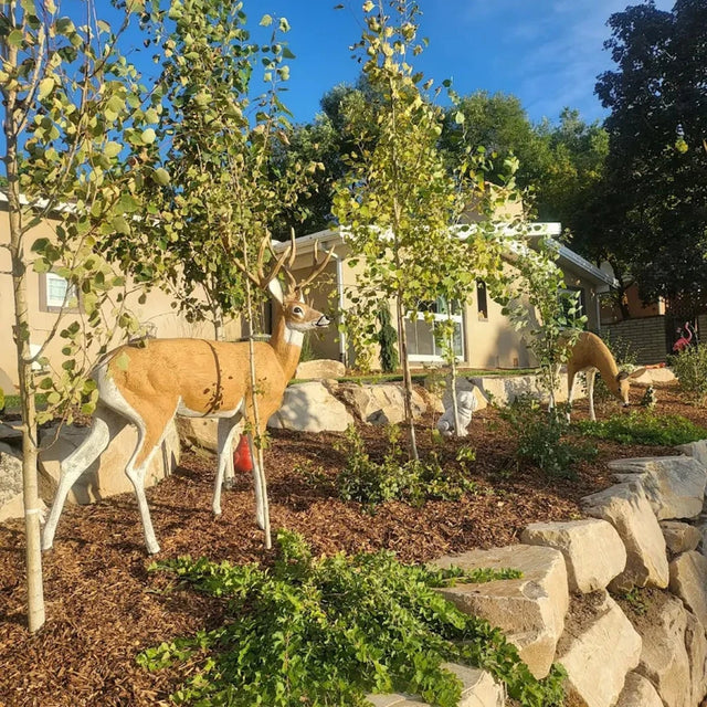 Cast aluminum deer doe with textured body in natural stance for outdoor displays.