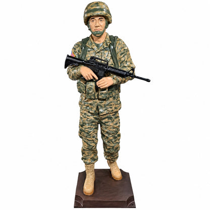 Cast aluminum 6-foot soldier holding a gun standing on a base.