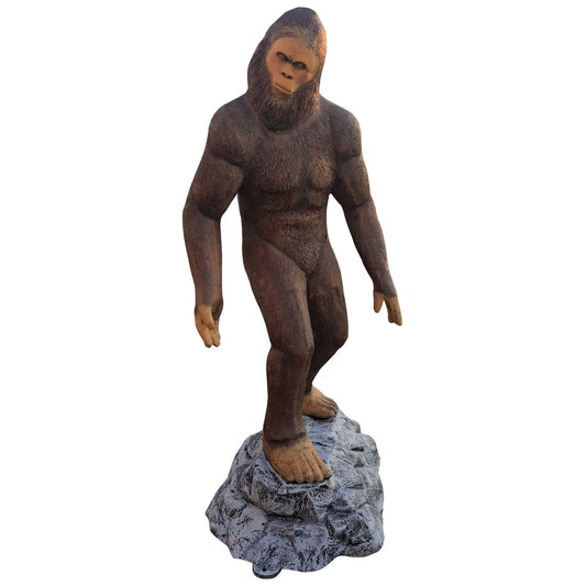 Cast aluminum Bigfoot statue for yard decor, standing on rock base, outdoor garden sculpture