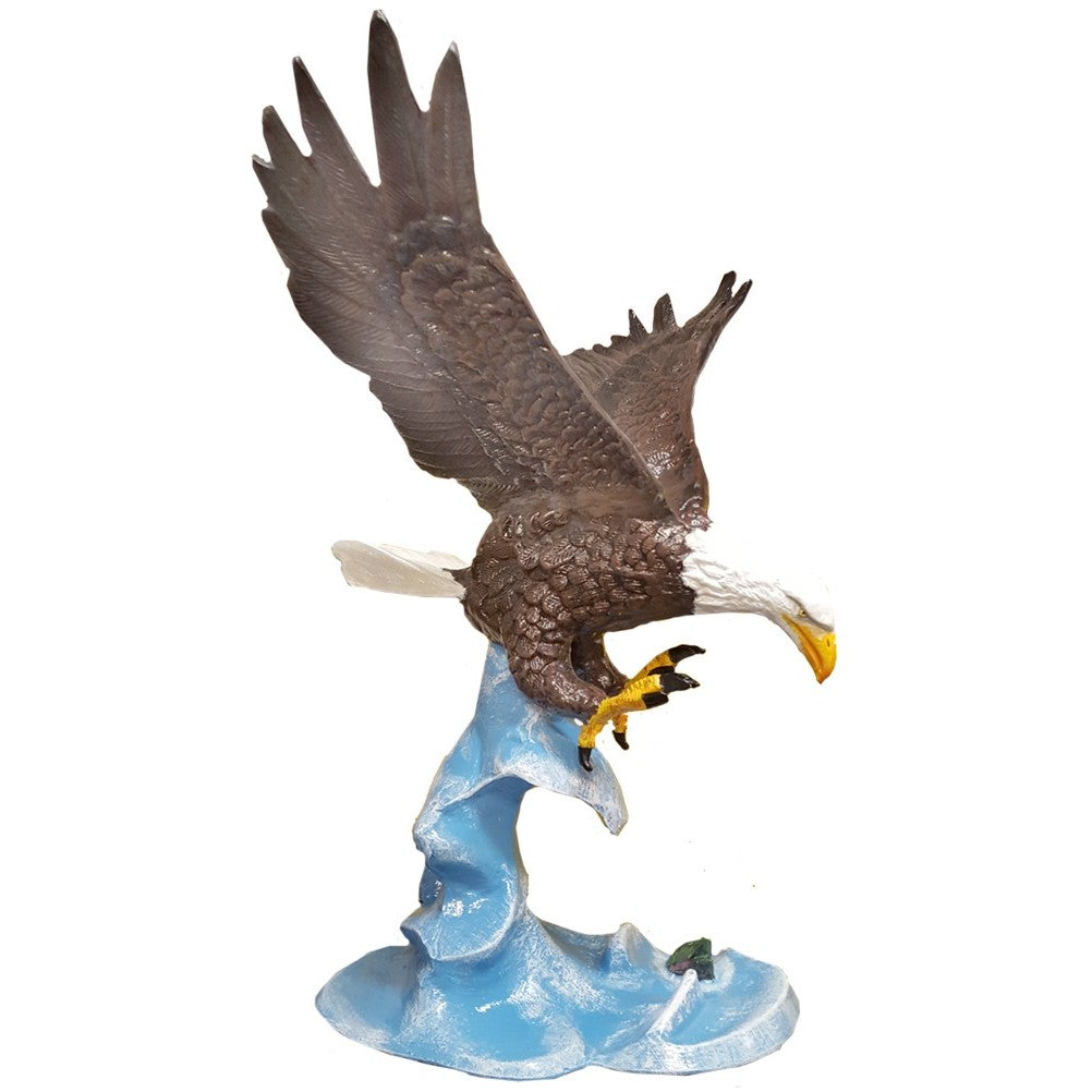 Cast aluminum bald eagle statue with outstretched wings, perched on blue wave base for yard or home decor.