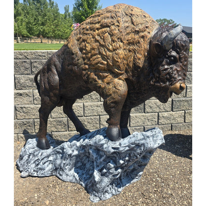 Cast aluminum bison statue for yard decor, detailed fur texture on rocky base, outdoor garden sculpture