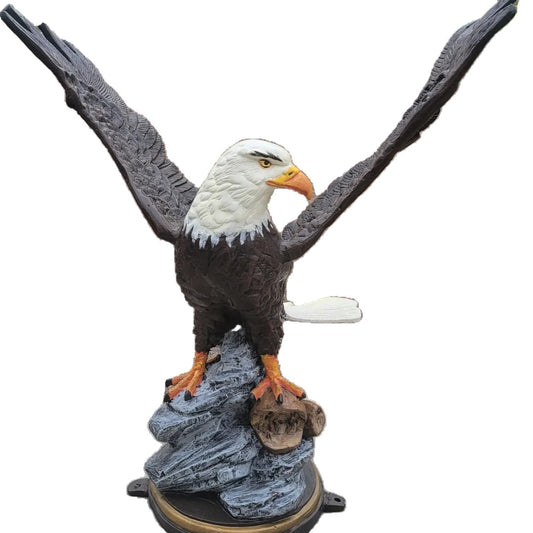 Cast aluminum bald eagle statue with wings spread, perched on rock base for yard or home decor