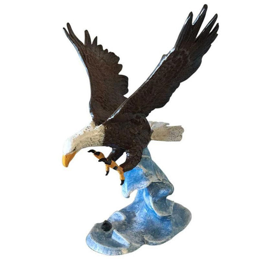 Cast aluminum bald eagle statue with outstretched wings, perched on rocky base for yard or home decor