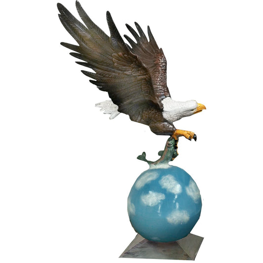 Cast aluminum bald eagle statue with outstretched wings perched on fish atop globe base for yard decor