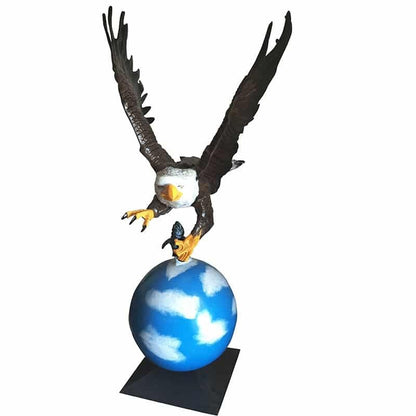 Cast aluminum eagle statue perched on globe, ideal for yard or home decor with detailed wings and talons.