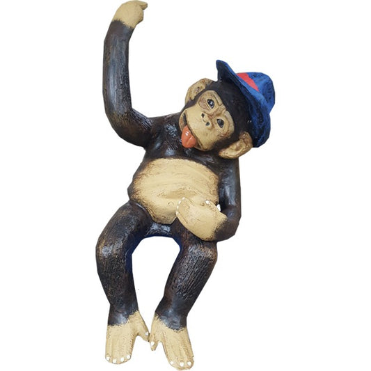 Cast aluminum monkey statue wearing blue hat, playful pose for yard or home decor