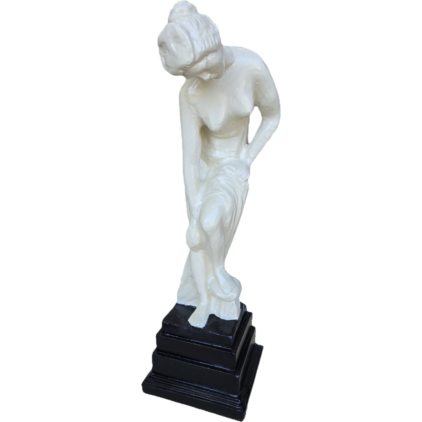 White cast aluminum statue of a woman bending, on black pedestal, for garden or home decor