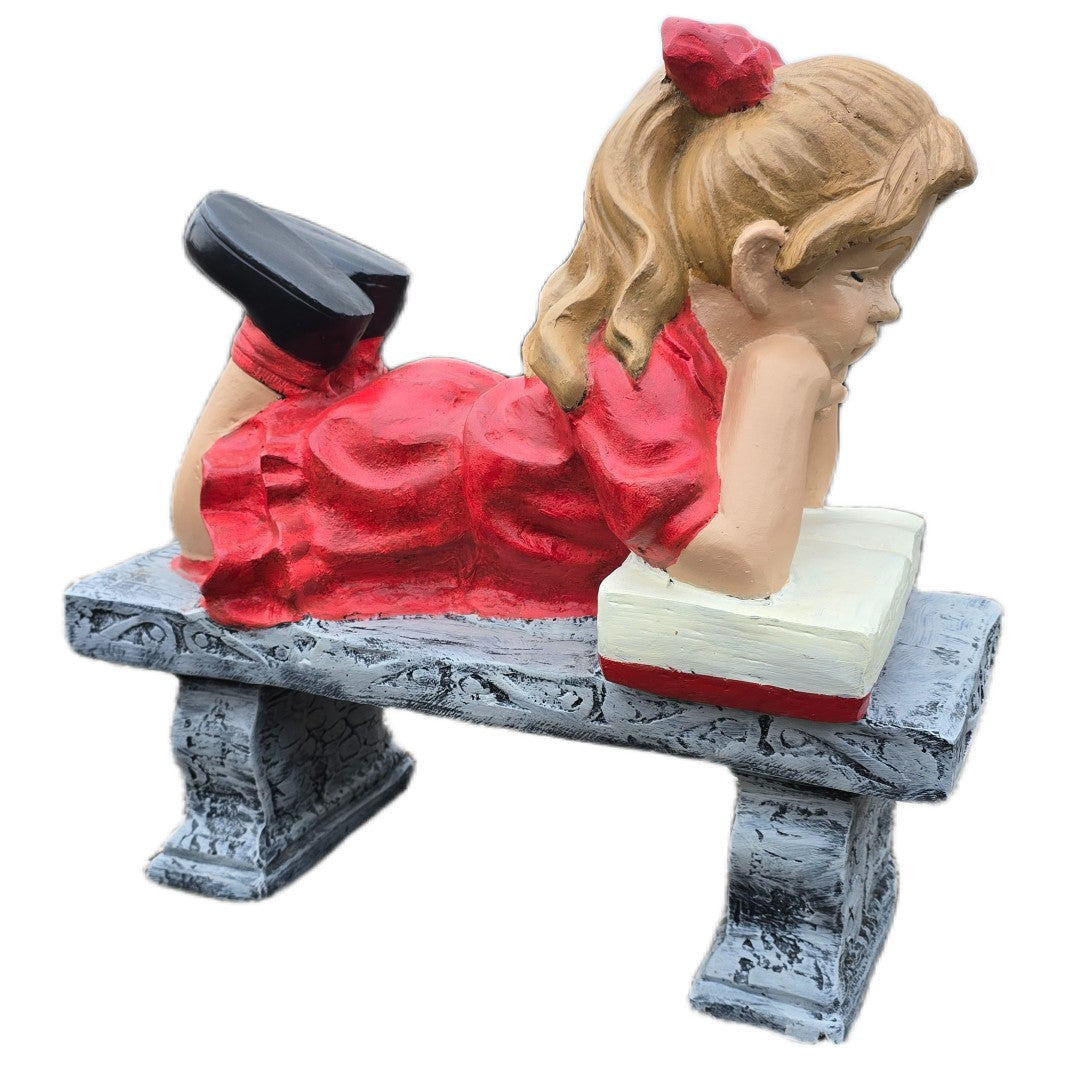 Cast aluminum girl statue in red dress reading book on bench, garden decor