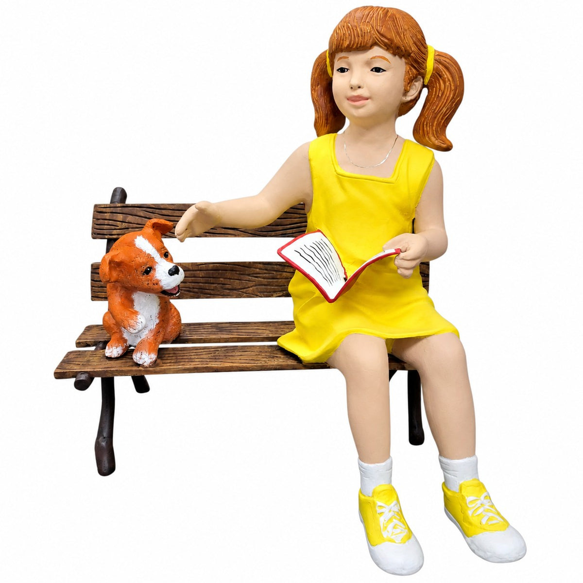 Cast aluminum girl reading and sitting on a bench with a dog.