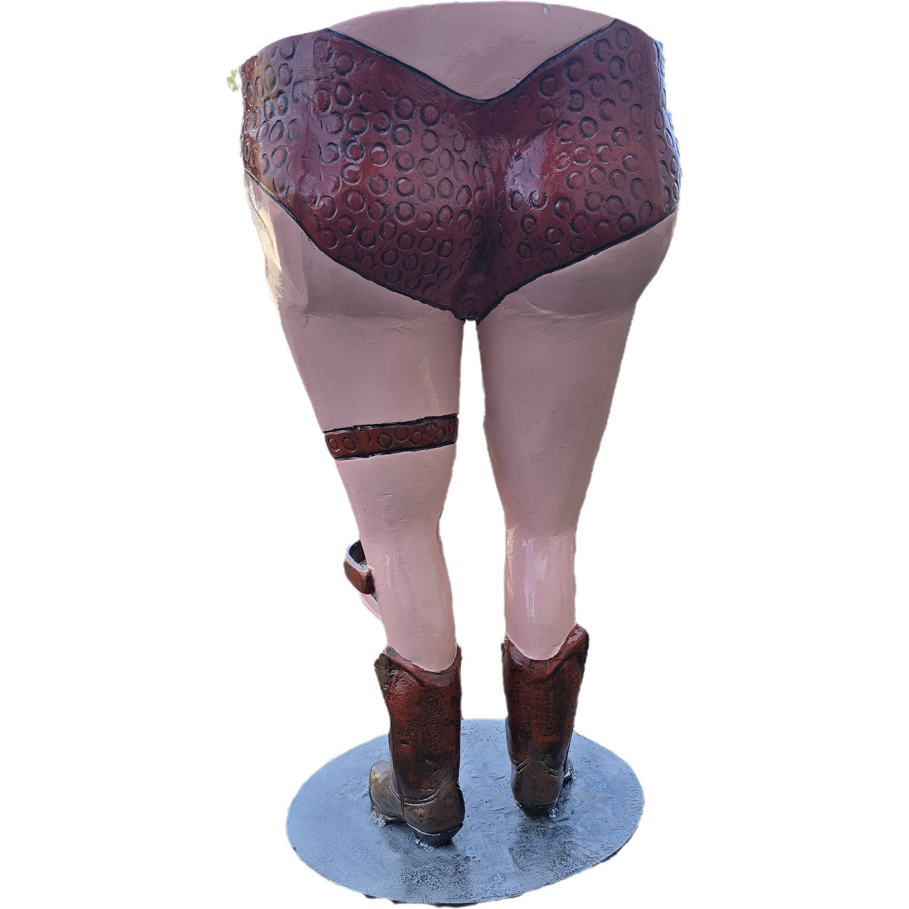 Cast aluminum statue of woman's legs in cowboy boots and patterned underwear, backyard decor