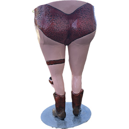 Cast aluminum statue of woman's legs in cowboy boots and patterned underwear, backyard decor