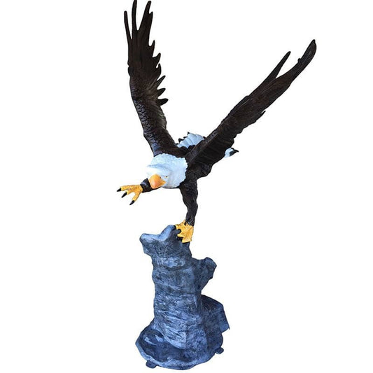 Cast aluminum bald eagle statue with outstretched wings perched on rock base for yard decor