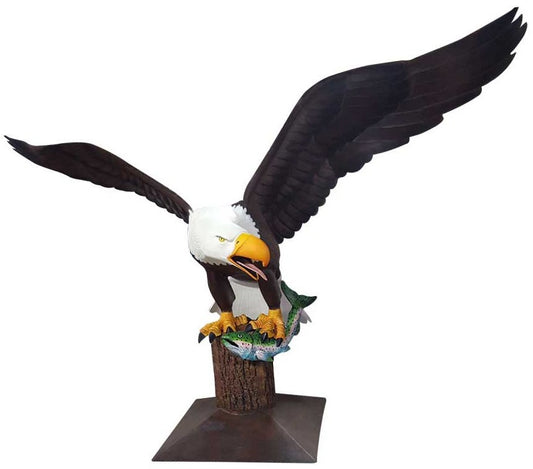 Cast aluminum bald eagle statue with spread wings clutching fish, perched on tree stump base for yard decor