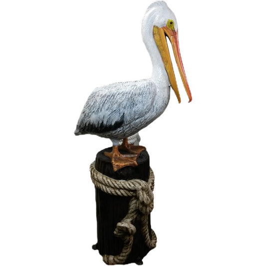 Cast aluminum pelican statue perched on rope-wrapped post for yard or home decor