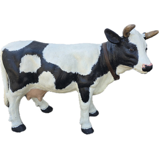 Cast aluminum cow statue with black and white spots, horns, and collar for yard or home decor