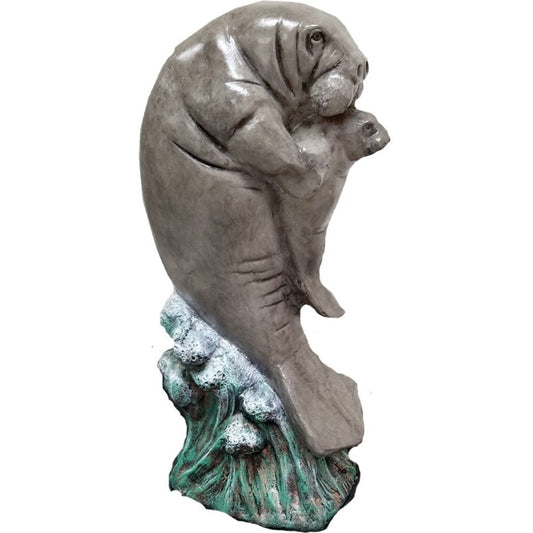 Cast aluminum manatee statue with calf, ideal for yard or home decor, featuring weathered green base