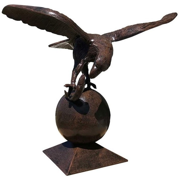 Cast aluminum eagle statue with outstretched wings perched on sphere, outdoor yard decor