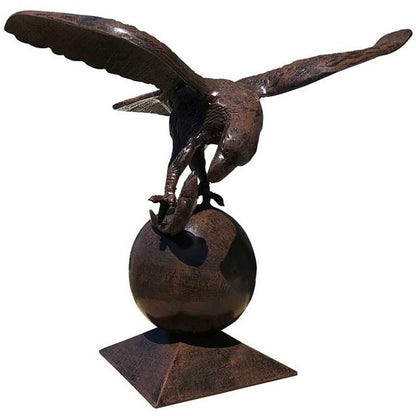 Cast aluminum eagle statue with outstretched wings perched on sphere, outdoor yard decor