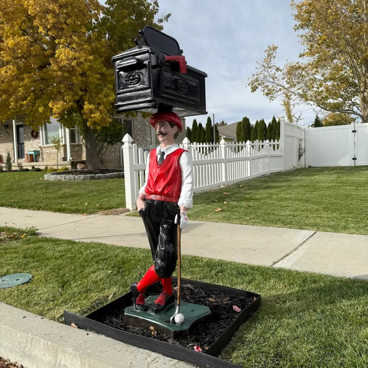 Cast aluminum mailbox on a golfer in red, white, and black colors