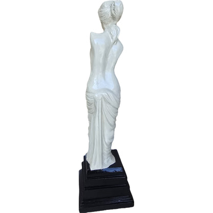 White cast aluminum goddess statue with draped gown on black pedestal, ideal for home or yard decor