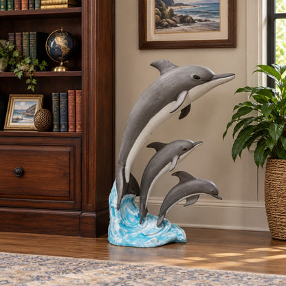 Cast aluminum statue of 3 dolphins on a wave for indoor or outdoor design spaces.