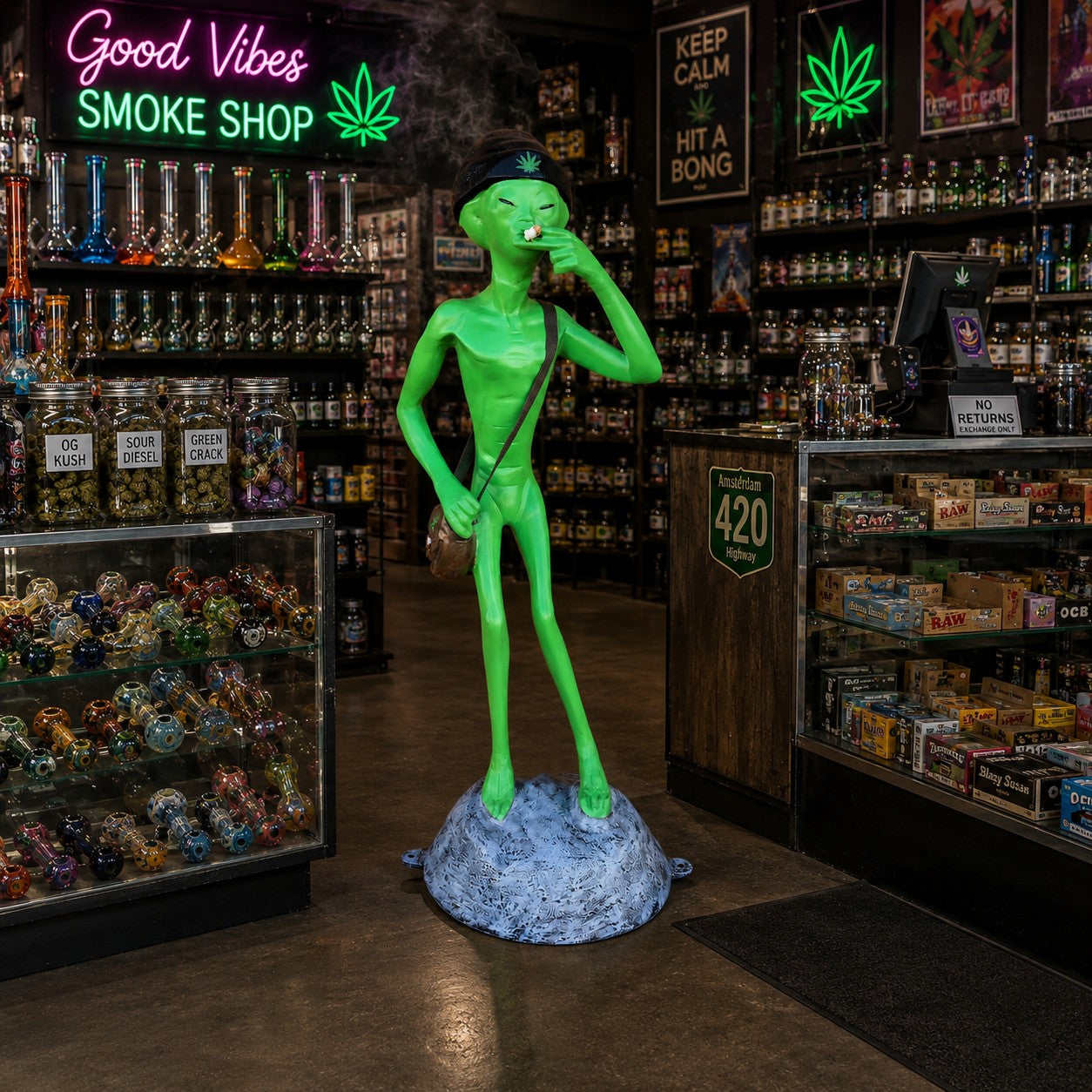 Cast aluminum green alien statue wearing beanie, holding joint, standing on rock base.