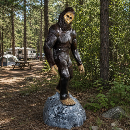 Cast aluminum Bigfoot statue for outdoor display, standing on rocky base