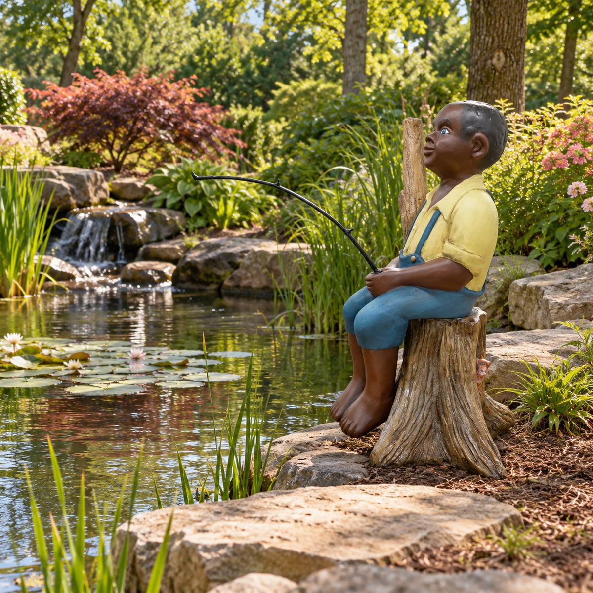 Cast aluminum large black colored boy sitting on a stump fishing.  Outdoor display statue.