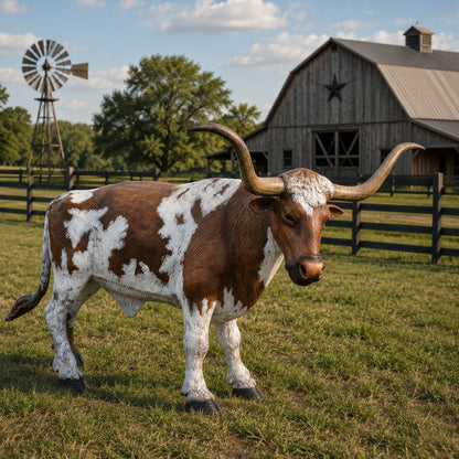 A longhorn cattle statue or decorative bull figure with brown and white patches 