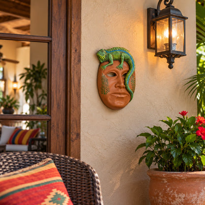 Tan mask with a green and blue lizard on top, green leaves on the sides for indoor or outdoor design spaces.