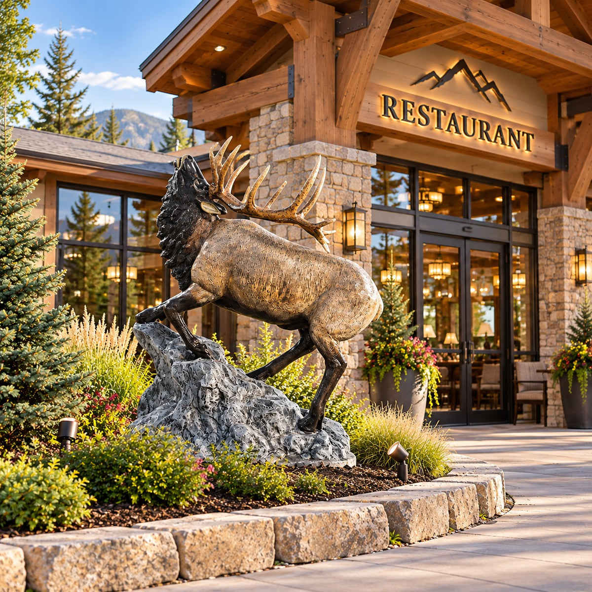 Cast aluminum elk statue with detailed antlers, standing on rocky base for yard or home decor