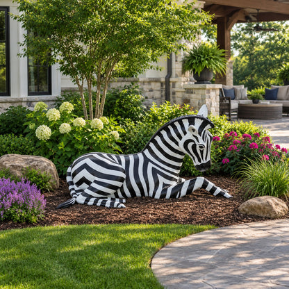 Cast aluminum zebra laying down for residential or commercial display or decor.