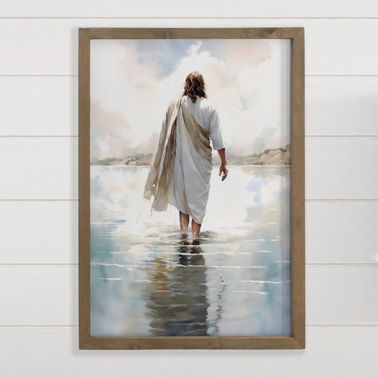 Framed wall art of a robed figure walking on water, serene sky reflection, rustic wood frame